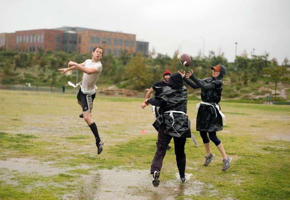 Flag football catch ponchos rain mud puddle