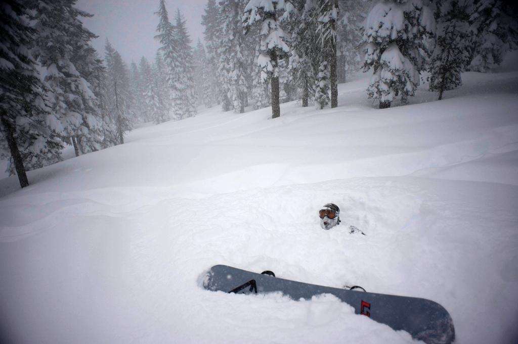 Fallen snowboarder deep powder
