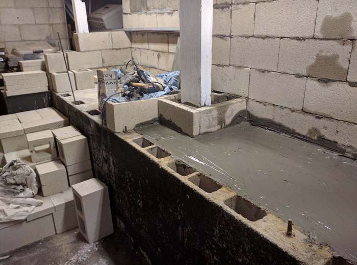 Renovation murder room concrete pour shelving cinder blocks