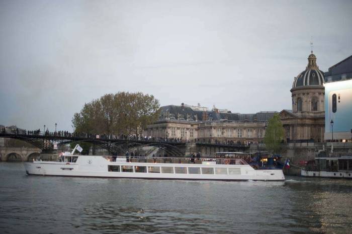 Paris France Seine boat tour people gathered watching Notre Dame fire 2019