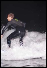 Night surfing flash inside wave