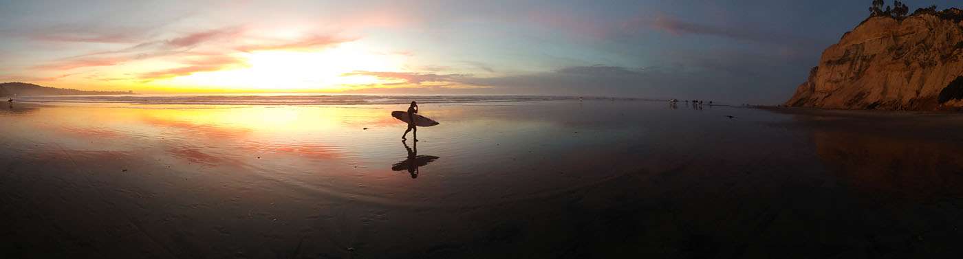 Blacks Beach San Diego sunset panorama with surfer