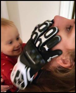 Toddler grabbing mother with Alpinestars gloves