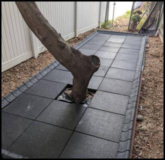 Sideyard renovation playground tile installation complete